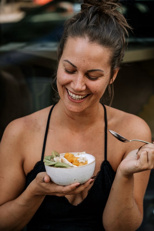 Smiling woman with a smoothie bowl